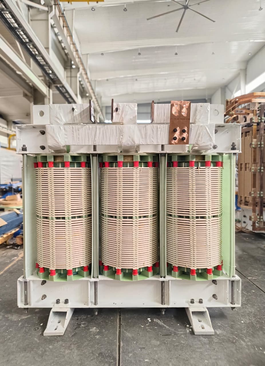 Dry-type transformer coils mounted on the base frame during assembly at the Tula Trans Electricals factory