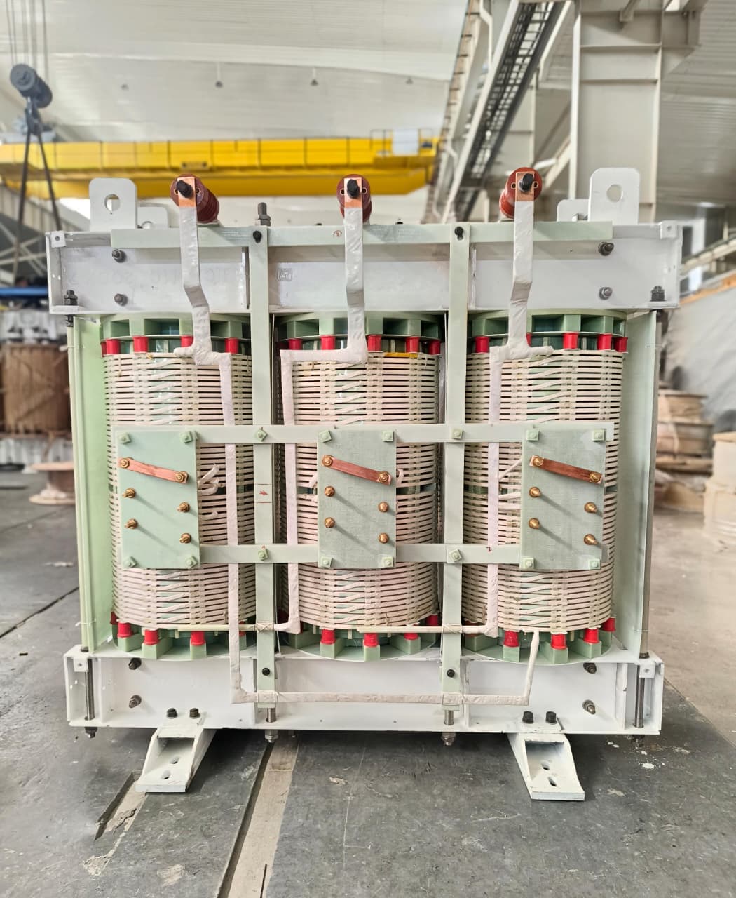 Core and coil assembly of a three-phase transformer clamped and braced on the shop floor at Tula Trans Electricals