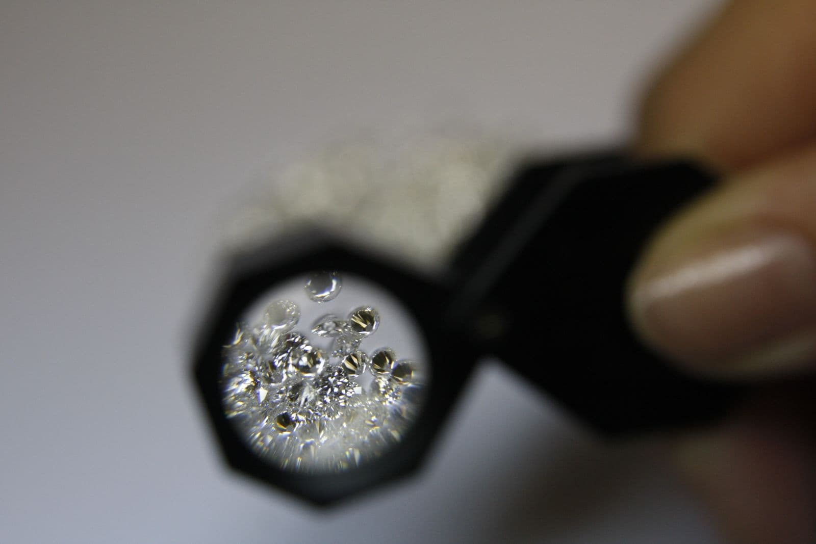 Polished diamonds seen through a jeweller’s loupe