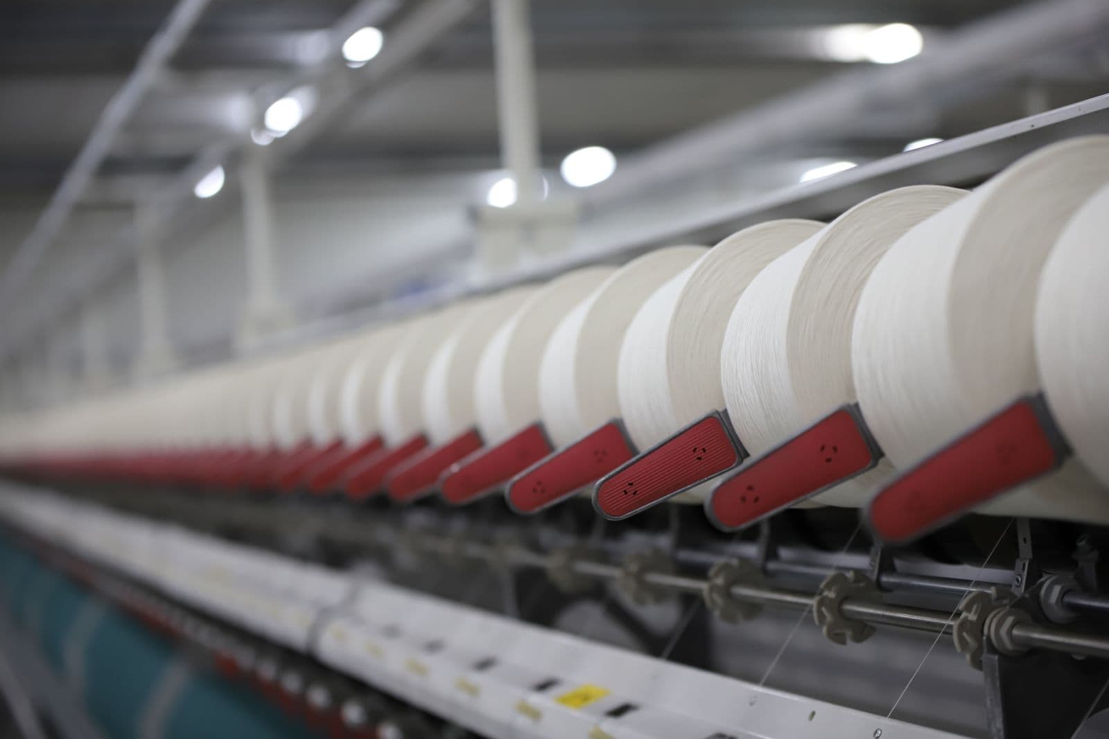 Yarn running through a spinning frame on a textile mill production line